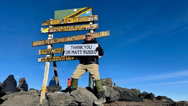 Patient Uday thanks Dr. Matthew Russo on top of Mt. Kilimanjaro